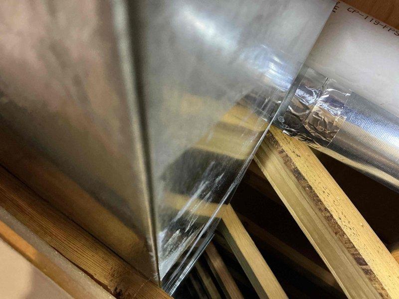 Responded to emergency water leak causing visible damage to interior walls and ceiling. Upon inspection, determined leak was not originating from secondary bathroom sink as initially suspected, but was caused by condensation accumulation on HVAC ductwork in attic space. Examined ductwork and identified inadequate insulation allowing moisture to form and drip onto ceiling below, resulting in water staining and structural concerns. Documented conditions with photographs of affected ductwork, wooden framing, and mechanical equipment. Recommended scheduling HVAC technician for proper return visit to address condensation issue through improved duct insulation or vapor barrier installation to prevent future moisture damage.