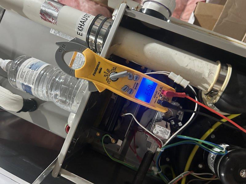 Performed annual furnace maintenance on 7-year-old system including complete operational testing, air filter replacement, and temperature rise verification. Cleaned flame sensor, tested igniter functionality, and cleared condensate drain line. Inspected air exchanger (found in satisfactory condition) and heat exchanger with no issues detected. Conducted capacitor testing on both inducer and blower motors using multimeter—blower motor capacitor tested weak and requires monitoring. Discovered oil leaking from underside of blower motor, indicating potential bearing failure. Demonstrated findings to homeowner on-site and documented condition with photos. System currently operating within normal parameters despite motor oil leak. Recommended warranty verification and provided information for potential blower motor replacement to prevent future failure.