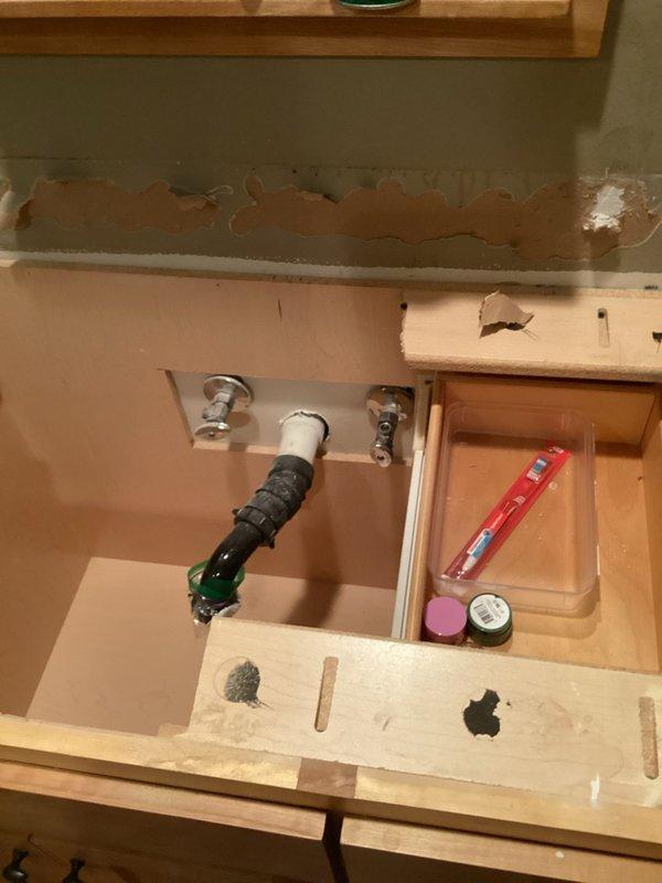 Responded to water leak service call requiring replacement of shut-off valves for multiple sink installations. Assessed plumbing connections for five sinks total, including three new sink installations and two existing fixtures in bathrooms and kitchen areas. Documented existing conditions through photography, revealing corroded supply valves and signs of water damage beneath bathroom vanity. Replaced defective shut-off valves with new chrome angle stops to restore proper water supply control. Installed new supply valves at all fixture locations to accommodate new sink hookups and ensure leak-free operation. Tested all connections for proper function and water flow restoration upon completion.