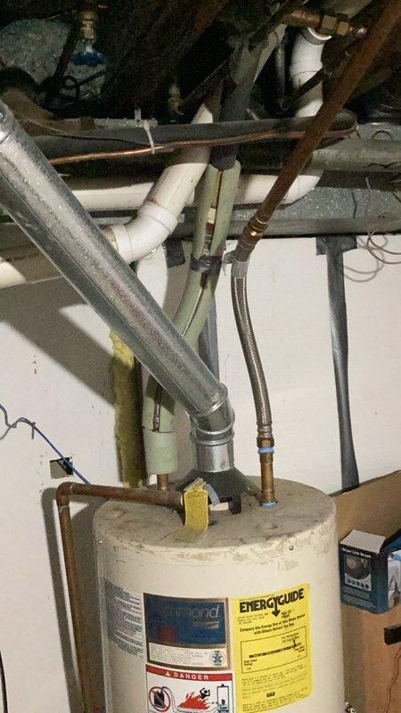 Responded to emergency water leak in shower causing damage to basement ceiling below. Upon inspection, identified failed shower cartridge and improperly sealed trim allowing water infiltration through flooring. Documented existing conditions with photographs of basement water heater area showing evidence of water damage and plumbing infrastructure. Provided detailed written estimates for cartridge replacement and proper caulking of shower trim to prevent future water intrusion.