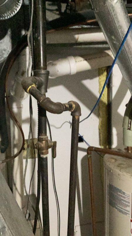 Responded to emergency water leak in shower causing damage to basement ceiling below. Upon inspection, identified failed shower cartridge and improperly sealed trim allowing water infiltration through flooring. Documented existing conditions with photographs of basement water heater area showing evidence of water damage and plumbing infrastructure. Provided detailed written estimates for cartridge replacement and proper caulking of shower trim to prevent future water intrusion.