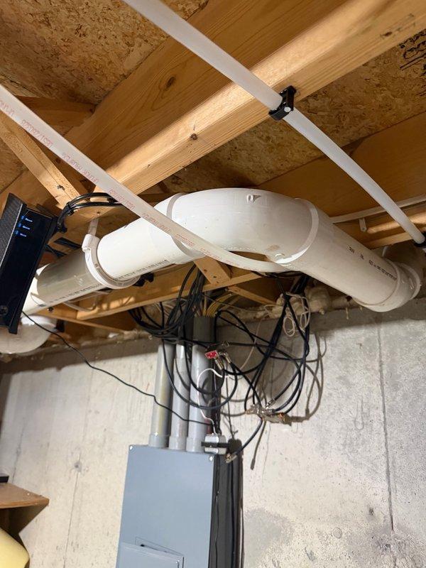 Responded to callback for knocking sounds in hot water lines under master bathroom floor. Upon inspection, identified unsupported PEX hot water pipe near vanity causing knocking when faucet activated. Added proper pipe support to eliminate rubbing and reduce noise. Advised homeowner that some residual creaking may occur in floor joists during thermal expansion as pipes heat up, which is normal behavior for the installation.