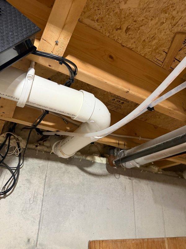 Responded to callback for knocking sounds in hot water lines under master bathroom floor. Upon inspection, identified unsupported PEX hot water pipe near vanity causing knocking when faucet activated. Added proper pipe support to eliminate rubbing and reduce noise. Advised homeowner that some residual creaking may occur in floor joists during thermal expansion as pipes heat up, which is normal behavior for the installation.