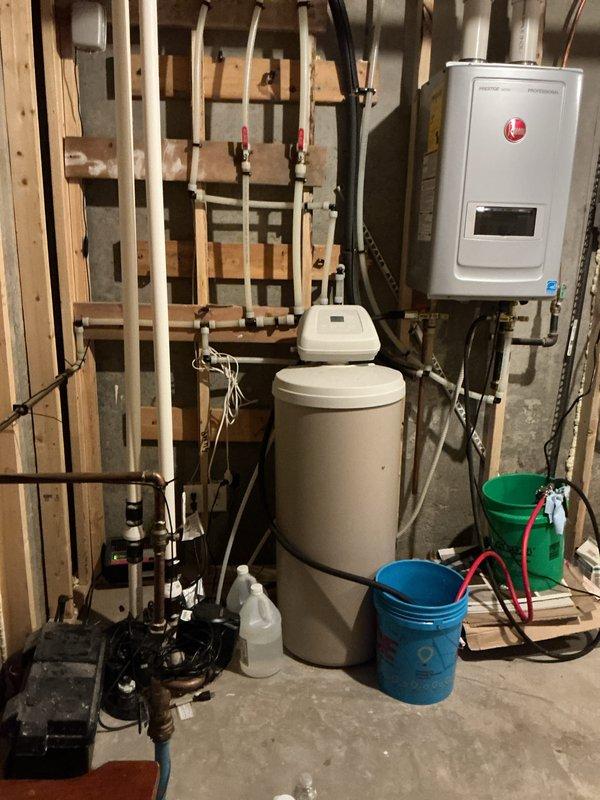 Completed pre-paid maintenance visit at commercial property for recurring plumbing inspection service. Performed comprehensive inspection and descaling of 8-year-old tankless water heater unit. Flushed system according to manufacturer specifications to remove mineral buildup and ensure optimal performance. Inspected mechanical room plumbing infrastructure including water softener system, supply lines, and associated valving. Inspected toilet tank components and noted mineral deposits consistent with hard water conditions. All systems operational upon completion. Customer requested advance notification upon arrival, which was provided.