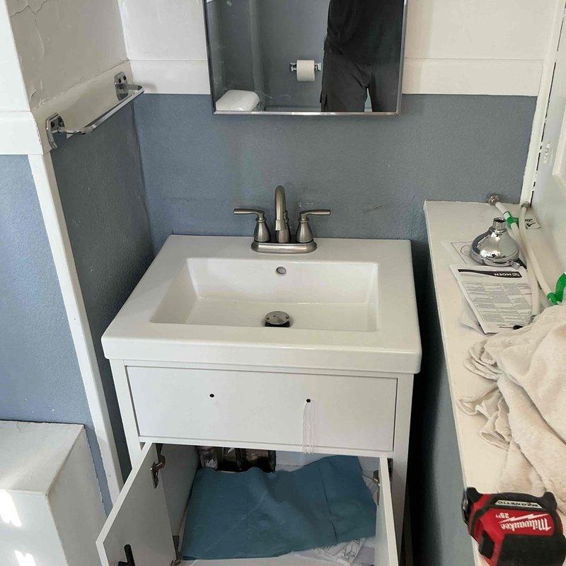 Completed emergency plumbing installation for bathroom remodel after previous contractor failed to appear. Installed customer-supplied fixtures including new bathroom lavatory faucet with brushed nickel dual-handle configuration and shower assembly with chrome handheld showerhead, bracket mount, and tub spout. All fixtures properly connected, tested for leaks, and confirmed operational. Total service time: 2 hours.