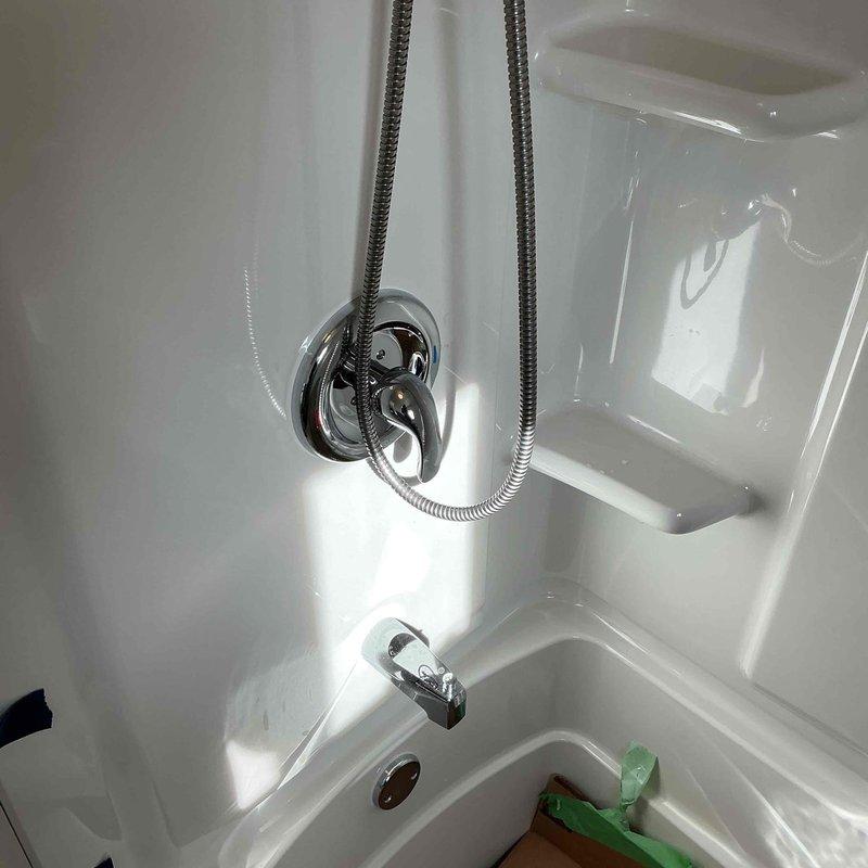 Completed emergency plumbing installation for bathroom remodel after previous contractor failed to appear. Installed customer-supplied fixtures including new bathroom lavatory faucet with brushed nickel dual-handle configuration and shower assembly with chrome handheld showerhead, bracket mount, and tub spout. All fixtures properly connected, tested for leaks, and confirmed operational. Total service time: 2 hours.