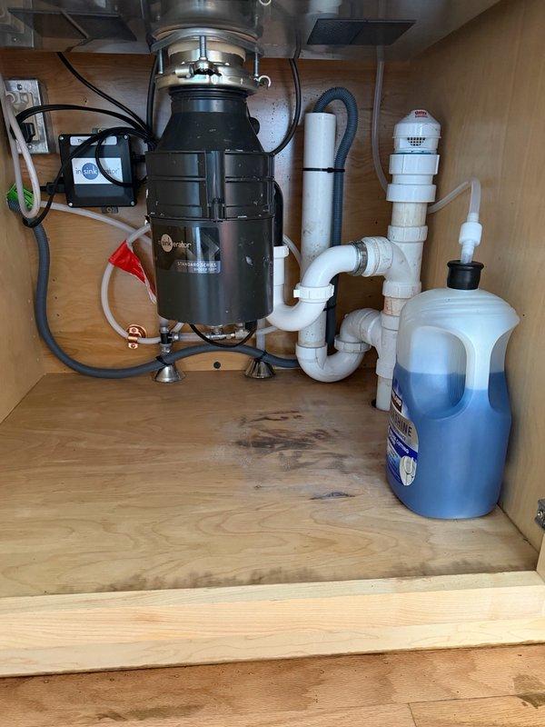 Responded to kitchen sink drain stoppage caused by lemon peel lodged in garbage disposal system. Customer had attempted multiple clearing methods without success. Utilized drain auger to successfully clear obstruction from kitchen sink drain line. Verified proper drainage and water flow upon completion. Plumbing system restored to normal operation.