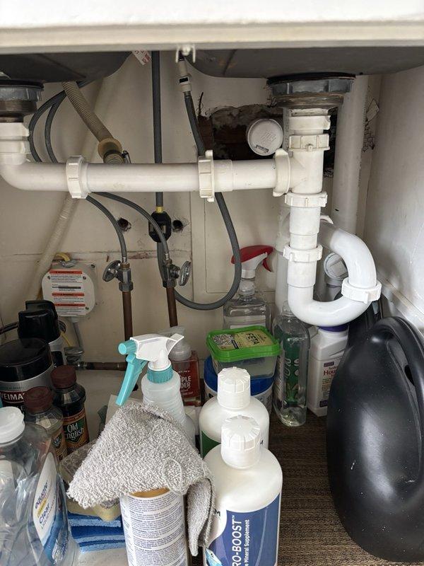 Performed comprehensive annual plumbing inspection including water and drain lines in basement, flushed recently installed water heater, and inspected laundry tub, toilet, and exterior faucet shut-off valves. Conducted fixture inspections on main level and performed hard water testing. All plumbing systems, water heater, and fixtures tested within normal operating parameters with no immediate concerns identified. Discovered structural cracks on underside of laundry tub showing early signs of water seepage and provided replacement estimate for laundry tub and faucet assembly.
