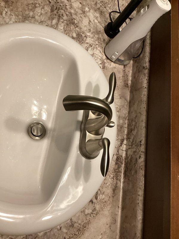 Completed comprehensive plumbing inspection of residential property including kitchen and bathroom fixtures. Inspected kitchen double basin sink, faucet assembly, and drainage systems; all components found in proper working order. Evaluated bathroom vanity sink, faucet with dual lever handles, and associated plumbing connections with no issues identified. Noted presence of toilet bowl cleaner tablets in toilet bowls and recommended removal to prevent potential damage to internal flush valve components and seals. All photographed fixtures showed proper installation and no visible leaks or deterioration.