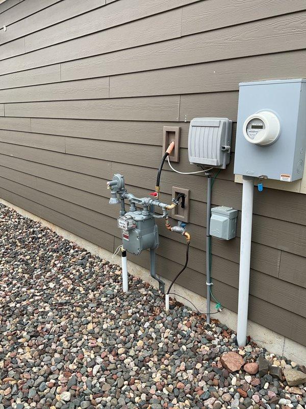 Completed HVAC installation callback to address gas line routing issues. Installed 4-inch stainless steel tee and applied gas line lubricant to establish proper gas connection to exterior meter assembly. Performed pressure test with gauge to verify system integrity and confirmed all connections are gas-tight and meet code requirements.