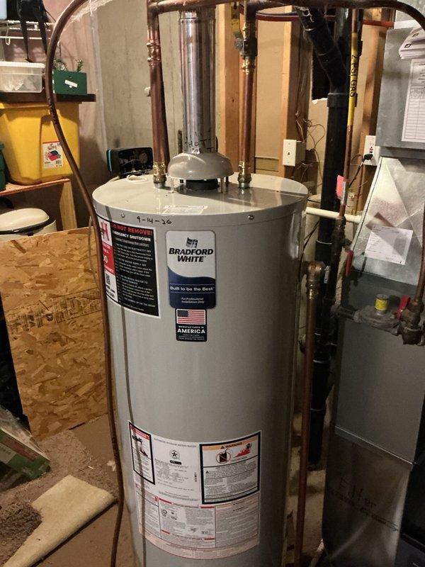 Responded to emergency service call for leaking 21-year-old natural gas 40-gallon water heater. Upon inspection, confirmed active leak from tank indicating internal failure beyond economical repair. Disconnected and drained existing unit, then removed failed water heater from utility area. Installed new Bradford White 40-gallon natural gas water heater to manufacturer specifications. Connected copper supply and distribution lines with proper brass fittings and shut-off valves. Installed code-compliant temperature and pressure relief valve with discharge pipe. Verified all gas connections for proper operation and leak-free performance. Tested unit functionality and confirmed proper ignition, burner operation, and hot water delivery throughout home plumbing system. Removed old water heater from premises and left work area clean.