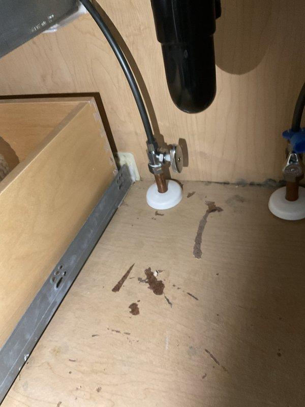 Responded to water leak in main bathroom caused by faulty shut-off valve beneath the sink. Removed and replaced the defective valve with new chrome shut-off valve and escutcheon plate. Tested the new installation to verify proper operation and confirmed no active leaks present.