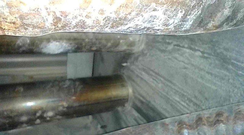 Completed annual heating maintenance tune-up on a 25-year-old Goodman furnace. Performed comprehensive inspection revealing several age-related concerns including rust staining in lower right inducer chamber, elevated inducer motor amp draw, rust on heat exchangers (no cracks detected), and high resistance reading on hot surface ignitor at 114.1 ohms. Cleaned flame sensor by reaching through burner assembly as sensor was seized and could not be removed. Tested blower motor capacitor reading 9.2µF on 10µF rated unit. Cleared condensate drain line by blowing compressed air through system. Documented all findings with photos and provided replacement estimates for aging components; homeowner elected to decline repairs at this time and continue monitoring system performance.