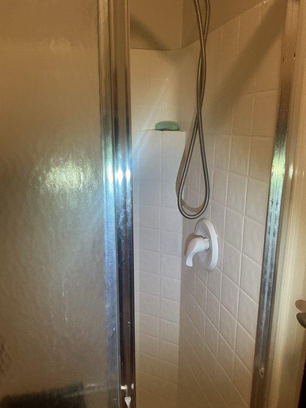 Completed comprehensive plumbing inspection of residential bathroom fixtures including sink, faucet, drain assembly, and shower system with glass enclosure. All fixtures were visually examined for proper operation, leaks, and potential maintenance concerns, with photographic documentation captured for service records.