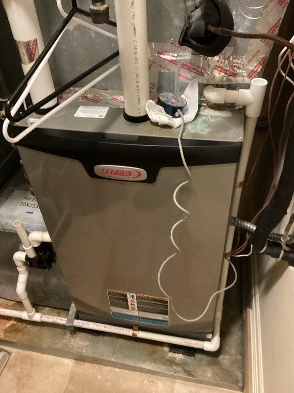 Responded to callback for inadequate cooling upstairs with unit running continuously without reaching setpoint. Found evaporator coil completely frozen over due to insufficient airflow. Vacuumed water from system, dried safety switch, and installed temperature sensor. Recommended installation team perform ductwork modifications to increase airflow across coil and prevent future freeze-ups.