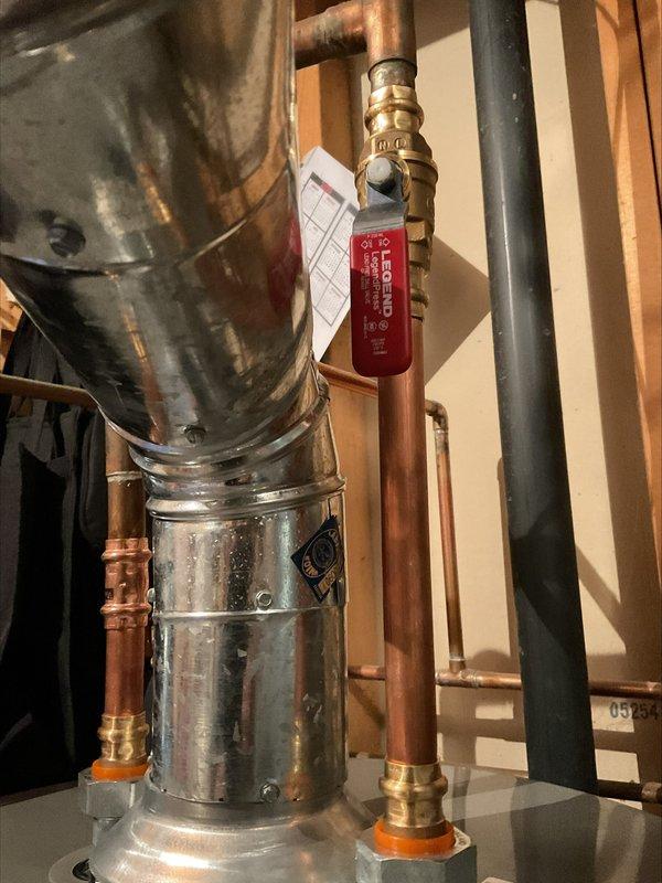 Responded to callback for code correction involving gas and water shut-off valves that were not closing completely due to interference from adjacent vent piping. Adjusted vent pipe positioning to establish proper clearances, allowing both valves to achieve full shut-off capability and meet safety code requirements. Documented corrected installation with photographs showing proper valve operation and adequate spacing between components.