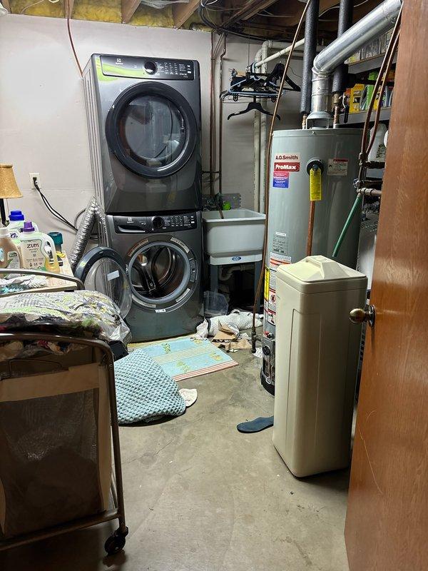 Responded to no hot water call for 16-year-old 50-gallon A.O. Smith water heater. Successfully relit pilot light and restored temporary function, but due to unit's age and condition, recommended full replacement. Customer approved installation of new A.O. Smith ProMax water heater and replacement of laundry tub. Completed water heater replacement with proper venting and plumbing connections, installed new laundry tub, and verified all systems operational before departure.