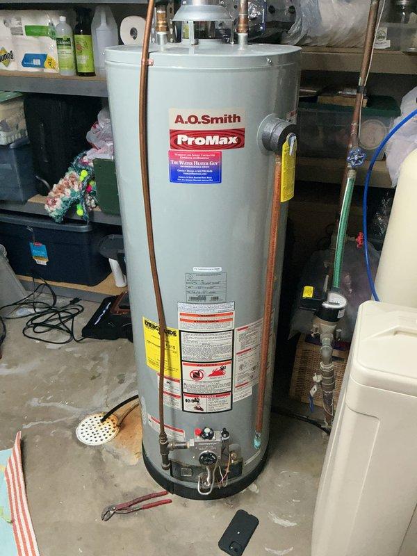 Responded to no hot water call for 16-year-old 50-gallon A.O. Smith water heater. Successfully relit pilot light and restored temporary function, but due to unit's age and condition, recommended full replacement. Customer approved installation of new A.O. Smith ProMax water heater and replacement of laundry tub. Completed water heater replacement with proper venting and plumbing connections, installed new laundry tub, and verified all systems operational before departure.