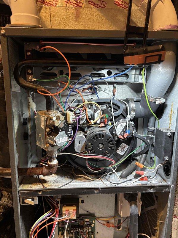 Performed comprehensive furnace tune-up and maintenance on a 6-year-old heating system. Conducted thorough inspection of thermostat operation, indoor air handler components, air filter, condensate drain, blower motor, inducer motor, run capacitor, and all electrical wiring connections—all found to be functioning properly. Verified temperature split across the system within acceptable range. Inspected heat exchanger for cracks or deterioration, flame sensor operation, and igniter functionality—all components in good condition. Measured gas pressure at manifold and identified gas valve was overfeeding, causing excessive pressure. Adjusted gas valve to bring manifold pressure within manufacturer specifications for safe and efficient operation. Verified proper flame characteristics and burner operation following adjustment. System tested and confirmed to be operating normally with all safety controls functioning as designed.