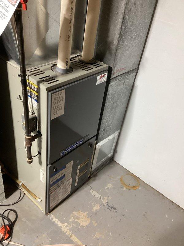 Responded to no heat call on 18-year-old American Standard furnace. Performed diagnostic testing and identified failed heat exchanger with burners not fully igniting. Observed unit would operate when access panel was removed, indicating combustion/gas valve malfunction. Documented findings with photos showing debris accumulation in heat exchanger and overall unit condition. Scheduled furnace replacement estimate due to age of equipment and extent of failure.