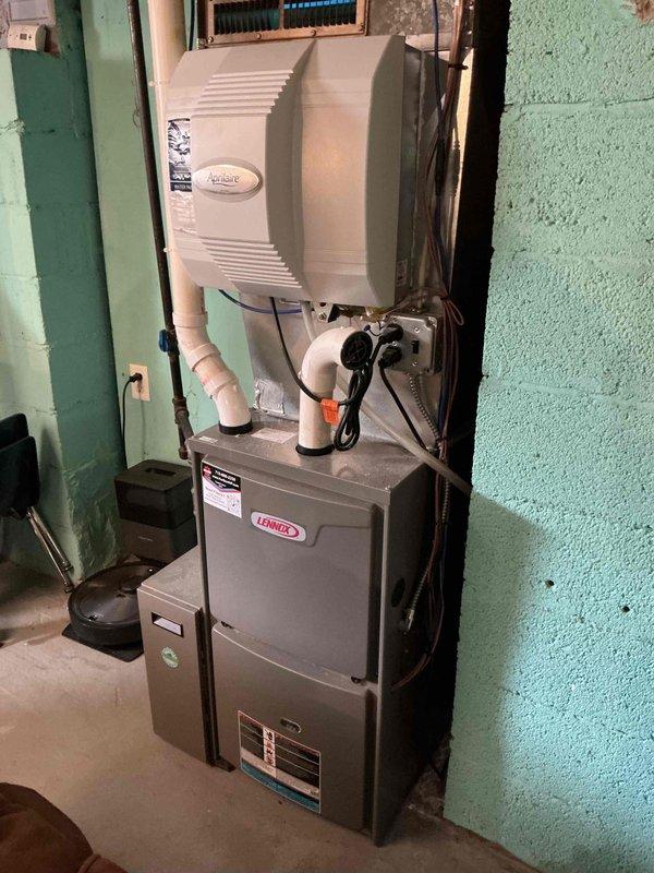 Completed scheduled heating maintenance on Lennox furnace system. Performed comprehensive inspection including cleaning flame sensor, verifying all electrical components and connections, confirming evaporator drain and pressure switch hoses were clear and functioning properly. Inspected heat exchanger and burners which were found to be in good condition. Verified proper gas pressure settings and confirmed unit operation with 55-degree temperature rise across heat exchanger. Noted 5-inch air filter showed minor dirt accumulation but remained serviceable, with homeowner planning replacement. System operating within manufacturer specifications with no deficiencies noted.