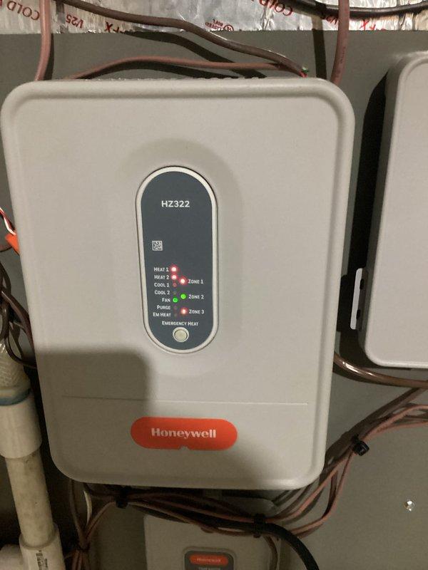 Responded to heat pump blowing cool air complaint and discovered Honeywell HZ322 zone panel was not properly configured for heat pump operation. Corrected zone panel settings and coordinated with Honeywell technical support to verify proper communication between all system components and remotely reset the internet interface module. System now operating correctly in heating mode with all zones functioning as designed.