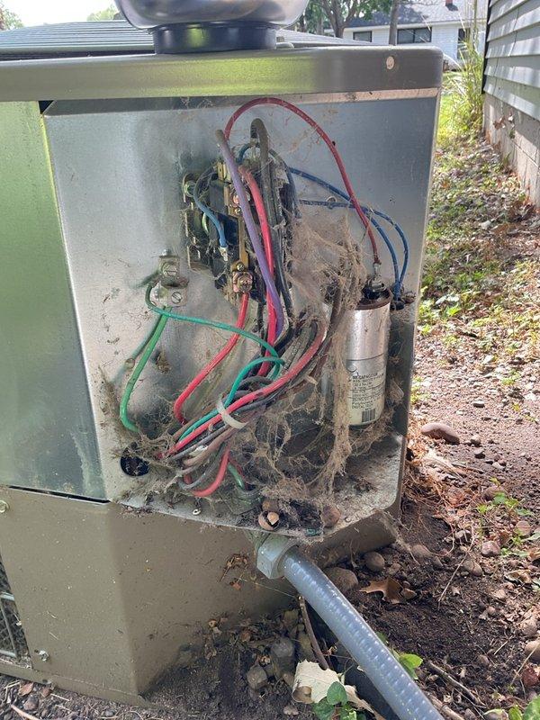 Performed comprehensive HVAC maintenance inspection on 2005 York R-22 air conditioning system and furnace. Discovered severe evaporator coil airflow restriction with approximately 80% blockage, damaged suction line, and refrigerant circuit restriction causing abnormal suction and head pressures. Identified active gas leak at furnace burner orifice and manifold area requiring immediate shutdown for safety. Documented extensive cobweb and debris accumulation in outdoor unit electrical compartment, corroded drain pan and cabinet areas with potential leakage, and aging capacitor with rust on terminal cap. Captured detailed photographs of equipment make, model, and serial numbers as requested, along with electrical components and system condition. Recommended complete system replacement due to equipment age (20 years), obsolete R-22 refrigerant, severely compromised evaporator coil, cabinet corrosion, and critical gas safety concern. Coordinated with homeowners to schedule consultation with