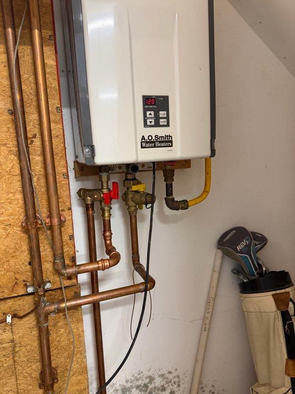 Performed routine maintenance service on an A.O. Smith tankless water heater unit. Flushed the tankless system to remove mineral buildup and sediment, cleaned the inlet filter to ensure proper water flow, and serviced the flame sensor and ignitor assembly to maintain optimal combustion efficiency. All components were inspected, cleaned, and confirmed to be operating within manufacturer specifications upon completion.