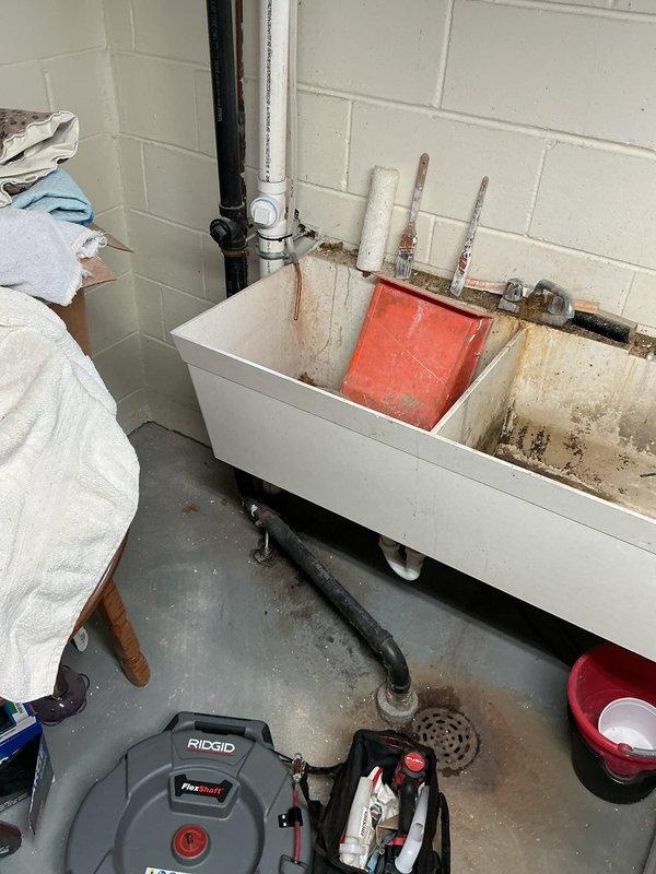 Responded to a kitchen/laundry drain system experiencing water backup after recent kitchen drain replacement. Upon initial diagnostic inspection, camera scoping revealed standing water at the point where the drain line transitions underground, indicating a blockage in the main line.

Performed mechanical cable cleaning of the drain line to its full accessible length, successfully removing a significant accumulation of lint and debris causing the obstruction. Following the cable work, conducted a complete camera inspection from the drain opening through to the mainline connection to verify full clearance and proper flow throughout the system.

Completed comprehensive flow testing at the laundry tub by filling and draining multiple cycles to confirm the drain system was operating at full capacity without any backup into the floor drain. All water discharged freely through the system, confirming successful restoration of proper drainage function.