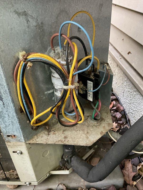 Responded to no-cooling complaint on 2001 Carrier R-22 air conditioning system experiencing repeat evaporator coil freeze-ups. Upon arrival, confirmed frozen evaporator coil and liquid line set. Performed diagnostic testing and found system operating with only 2.7–3°F subcooling versus manufacturer specification of 13°F after 10-minute run cycle, indicating low refrigerant charge or potential liquid-side metering/restriction issue. Verified air filter was clean and inspected outdoor condenser unit, finding no electrical defects or mechanical issues with condenser components. Documented visible corrosion and weathering on outdoor unit consistent with 20-year-old equipment age. Recommended full refrigerant leak detection, repair evaluation, and recharge to restore proper system operation and prevent continued freeze-up conditions. Additionally recommended pre-season heat exchanger inspection on paired Payne 40-inch furnace with polypropylene-lined secondary heat exchanger due to known is