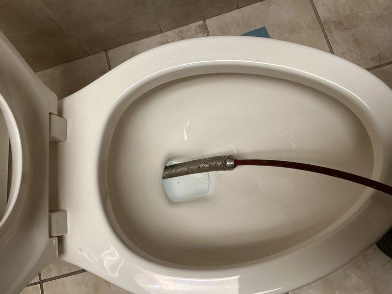 Responded to clogged toilet with poor flushing performance. Upon inspection, discovered soap bottle lodged in the P-trap causing the obstruction. Removed toilet from floor flange, extracted the foreign object from the trap, and reinstalled toilet with proper seal to restore full functionality.
