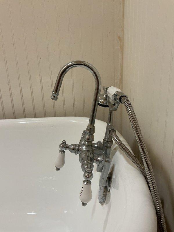 Responded to claw foot tub faucet failure with cold side handle detachment and inoperable diverter valve preventing switching between handheld sprayer and main spout. Disassembled vintage-style chrome faucet assembly to assess components, confirming broken diverter mechanism beyond repair. Documented existing hardware configuration and mounting specifications, then coordinated ordering of replacement faucet unit for subsequent installation to restore full functionality.
