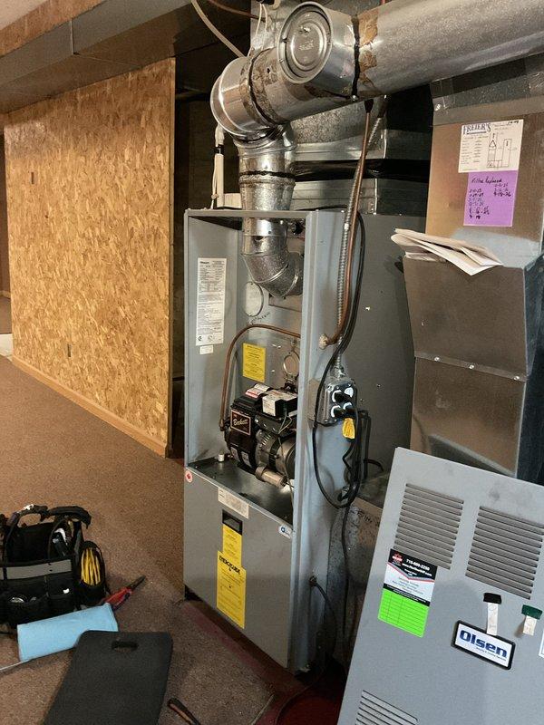 Completed comprehensive tune-up on oil furnace including nozzle replacement, heat exchanger inspection, electrode adjustment and cleaning, and installation of customer-supplied 25x20x5 air filter. Transformer tested and found to be operating at reduced capacity; provided estimate for T92 transformer replacement as preventive measure. System currently igniting properly, but recommended monitoring for any loud ignition sounds which would indicate need for transformer replacement.