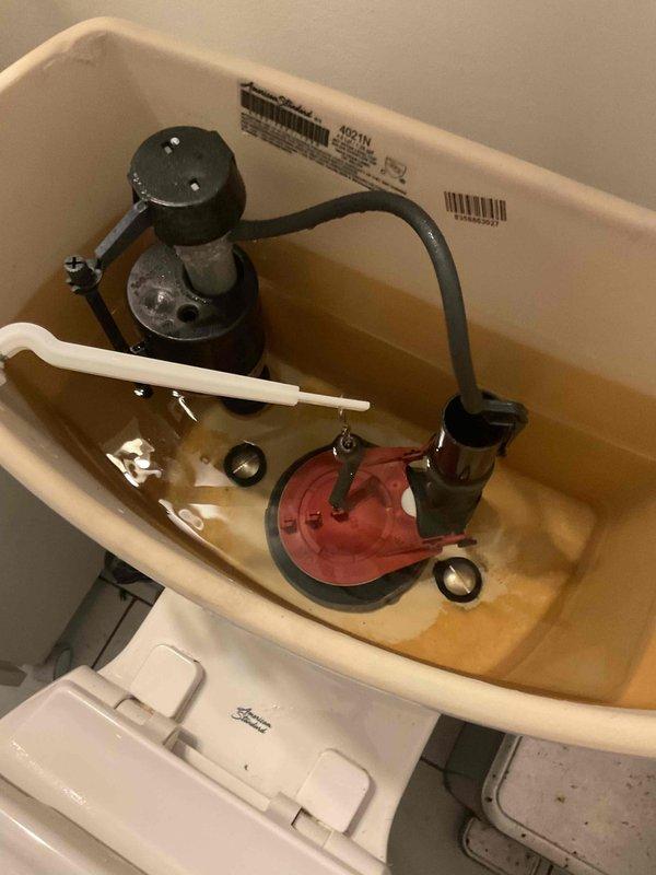 Responded to service call for continuously running toilet. Upon inspection, identified water leak caused by flapper valve not properly seating against the flush valve opening. Removed tank lid and examined internal components, noting discolored water in tank and debris accumulation on flapper sealing surface. Thoroughly cleaned the flapper flange and seating area to remove mineral deposits and buildup preventing proper seal. Tested flush mechanism to verify flapper now seats correctly and water flow stops after tank refill cycle completes. Leak resolved and toilet functioning properly.