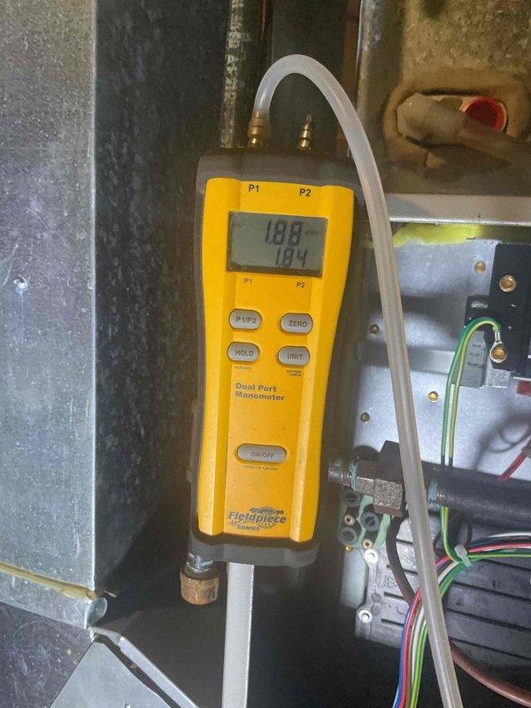 Replaced failed combustion inducer blower assembly and defective dual pressure switch on Carrier furnace. Verified proper draft pressure readings of 188 and 184 using calibrated manometer, confirming system is operating within manufacturer specifications and venting safely.