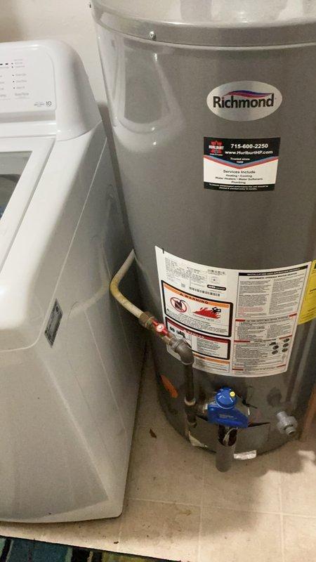 Responded to no hot water complaint at owner-occupied residential property. Upon arrival, found Richmond brand tanked water heater with pilot light that would not ignite or remain lit. Inspected gas supply, thermocouple, and pilot assembly for proper operation. Successfully relit pilot light and verified stable flame and proper burner operation. Tested hot water delivery to fixtures to confirm system functionality. Provided customer with replacement options and estimates for new water heater installation due to age and condition of existing unit. Unit currently operational following pilot relight.