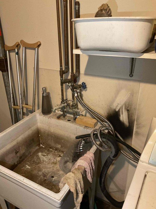 Completed routine plumbing inspection as part of recurring maintenance service. Inspected water heater unit (Rheem brand, 5+ years old) and found all components functioning properly with no leaks, corrosion, or safety concerns identified. Examined utility sink plumbing fixtures, valves, and supply lines; all connections secure and operational. Documented existing conditions including wall moisture staining near utility sinks and sediment accumulation in lower basin, which appear to be pre-existing cosmetic issues not affecting plumbing system performance. All plumbing systems inspected passed visual examination with no immediate repairs required.