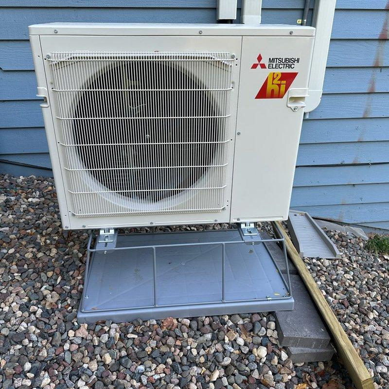 Returned to address two inspection failures on recent Mitsubishi Electric mini-split installation. Installed missing end cap on refrigerant line hide cover to meet code requirements. Investigated reported oily liquid leak on outdoor heat pump unit by operating system and performing thorough inspection of refrigerant lines and connections. Determined wet spot was normal condensation on refrigerant line, not oil or refrigerant leak. Verified system operation with indoor head unit running, confirmed no signs of oil residue or refrigerant leakage present. System operating properly and ready for re-inspection.