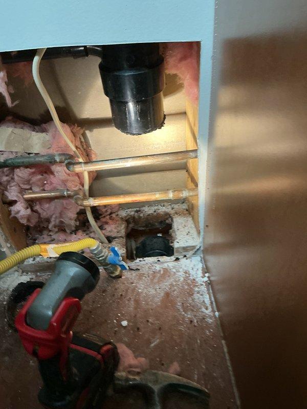 Responded to a water leak in the basement caused by a compromised 3-inch drain pipe servicing the upstairs bathroom vanity. Upon inspection, identified a hole in the drainage pipe between the kitchen and bathroom that was actively leaking when the vanity was in use. Removed the damaged section of 3-inch pipe, reamed out the connecting fitting to ensure proper seal, and installed a new pipe section. Utilized two Fernco couplings to complete the repair and restore proper drainage function.