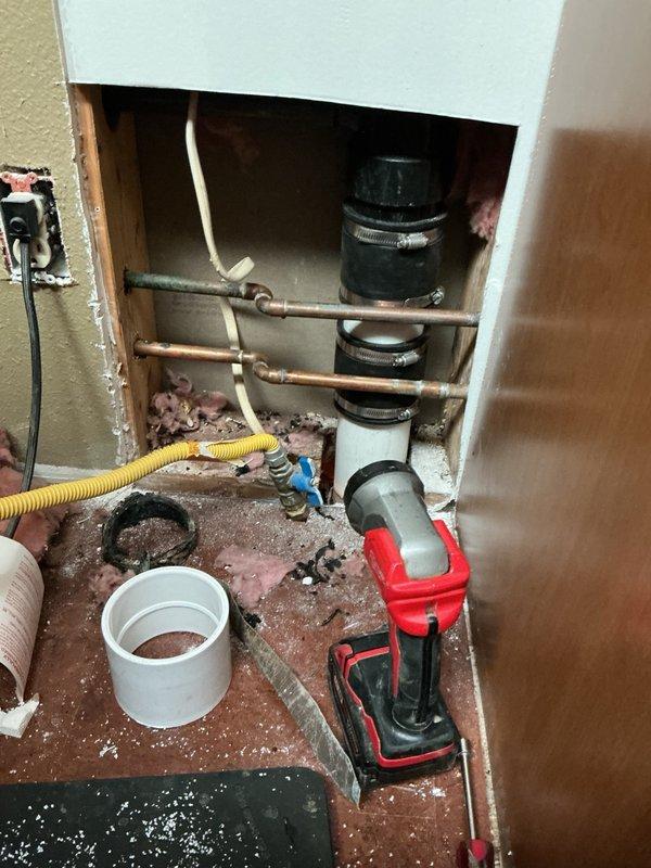Responded to a water leak in the basement caused by a compromised 3-inch drain pipe servicing the upstairs bathroom vanity. Upon inspection, identified a hole in the drainage pipe between the kitchen and bathroom that was actively leaking when the vanity was in use. Removed the damaged section of 3-inch pipe, reamed out the connecting fitting to ensure proper seal, and installed a new pipe section. Utilized two Fernco couplings to complete the repair and restore proper drainage function.