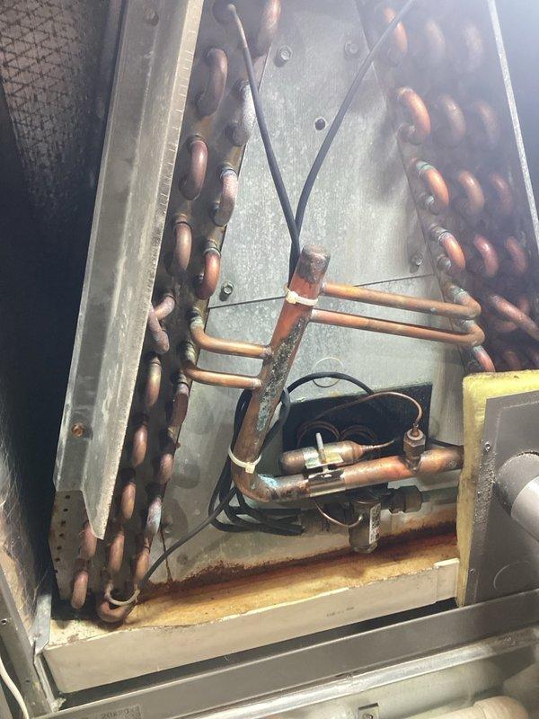 Performed air conditioning repair and boiler service on residential HVAC system. Confirmed low refrigerant condition in cooling system as previously diagnosed. Added 2 lbs of R410A refrigerant and UV dye to system for future leak detection and scheduled follow-up leak search. 

Inspected boiler and identified elevated carbon monoxide levels indicating improper combustion and ventilation. Cleaned burner assembly and lubricated inducer motor. Determined inducer motor is not functioning at optimal capacity, resulting in inadequate exhaust ventilation. Adjusted system to restore safe operating parameters and confirmed boiler returned to proper operation with acceptable combustion levels.