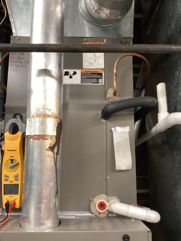Completed comprehensive maintenance tune-ups on two gas furnace systems with multi-zone configuration. Replaced 5-inch air filters on both units, performed standard safety inspections, verified proper operation of all zones and controls, and confirmed both systems are functioning correctly. Documented equipment condition with photos showing ductwork, insulation, and mechanical components; noted minor surface corrosion on duct connections but no operational concerns.