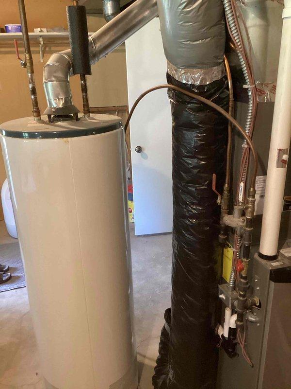 Conducted on-site assessment for customer-supplied tanked water heater installation. Performed visual inspection of existing utility room plumbing infrastructure, including water supply lines, drainage connections, and venting requirements. Evaluated installation feasibility, noting existing HVAC ductwork, electrical panel proximity, and floor-mounted plumbing configuration. Documented current conditions showing water heater positioning area with adjacent PVC drainage lines and copper supply piping. Identified necessary components and fittings required for proper installation. Initiated and submitted parts requisition form for required materials to complete installation per code requirements.