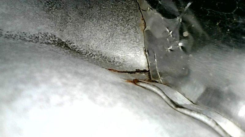 Performed scheduled heating maintenance on 2005 Trane high-efficiency furnace. During inspection, discovered two significant crimp cracks at the burner inlets of the left and center primary heat-exchanger cells, presenting a combustion-safety hazard. Additionally identified failing ECM inducer motor. Documented findings with photographs and discussed safety concerns with homeowner, reviewing repair versus replacement options. Homeowner scheduled follow-up appointment with service advisor to evaluate system replacement, noting the air conditioning unit was recently installed within the past two years.
