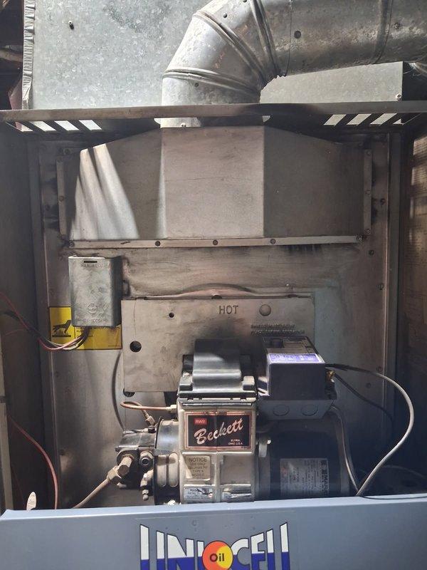Performed comprehensive tune-up and maintenance on 30-year-old oil furnace system that was experiencing heating issues and emitting a hot or burning smell from vents upon initial startup. Conducted full system inspection, replaced burner nozzle, and performed combustion analysis to ensure proper fuel-to-air ratio and efficient operation. Removed small piece of insulation material that had fallen onto the top of the heat exchanger, which was likely the source of the burning odor. Verified all components of the Beckett oil burner assembly were functioning correctly, checked electrical connections, and confirmed proper operation of the heating system. Unit tested and left in good working order.