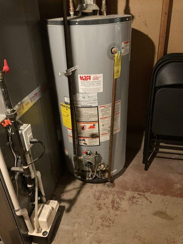 Responded to no hot water complaint at single-family residence. Upon arrival, inspected existing tanked water heater unit in basement utility room. Evaluated current system condition, including connected copper piping, control valves, and water treatment system. Documented equipment specifications and installation configuration. Provided customer consultation regarding tankless water heater conversion options as alternative solution to existing tank-style unit.