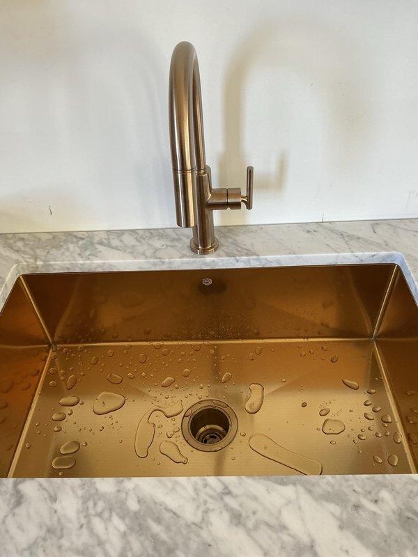 Completed comprehensive kitchen plumbing installation including new faucet, copper/bronze finish sink with basket strainer, supply line shut-off valves, and dishwasher hookup on marble countertop. Replaced sediment cartridge in whole-house water filtration system. Performed inspection of 9-month-old electric water heater. All fixtures tested and verified leak-free with proper operation confirmed.