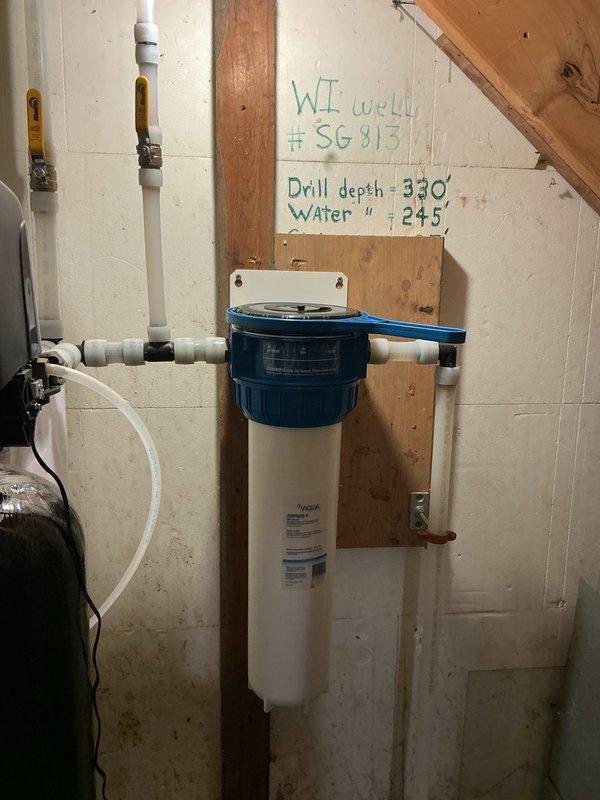 Completed comprehensive kitchen plumbing installation including new faucet, copper/bronze finish sink with basket strainer, supply line shut-off valves, and dishwasher hookup on marble countertop. Replaced sediment cartridge in whole-house water filtration system. Performed inspection of 9-month-old electric water heater. All fixtures tested and verified leak-free with proper operation confirmed.