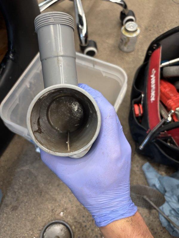 Responded to a commercial salon experiencing water leaks and drainage issues at multiple shampoo bowl stations. Upon inspection, discovered all four hair washing station P-traps were severely clogged with accumulated hair buildup, causing slow drainage, backups, and contributing to leak conditions. Disassembled and thoroughly cleaned each P-trap, removing substantial hair blockages and sediment from all trap assemblies. Reassembled all components with proper seals and connections. Conducted extended flow testing on each station for over five minutes to verify proper drainage function and confirm leak elimination. All stations now draining efficiently with no active leaks detected upon completion.
