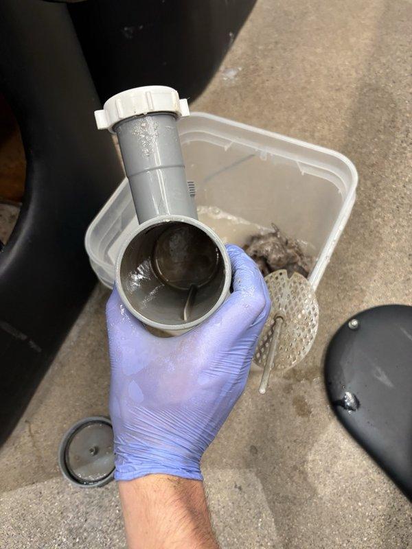 Responded to a commercial salon experiencing water leaks and drainage issues at multiple shampoo bowl stations. Upon inspection, discovered all four hair washing station P-traps were severely clogged with accumulated hair buildup, causing slow drainage, backups, and contributing to leak conditions. Disassembled and thoroughly cleaned each P-trap, removing substantial hair blockages and sediment from all trap assemblies. Reassembled all components with proper seals and connections. Conducted extended flow testing on each station for over five minutes to verify proper drainage function and confirm leak elimination. All stations now draining efficiently with no active leaks detected upon completion.